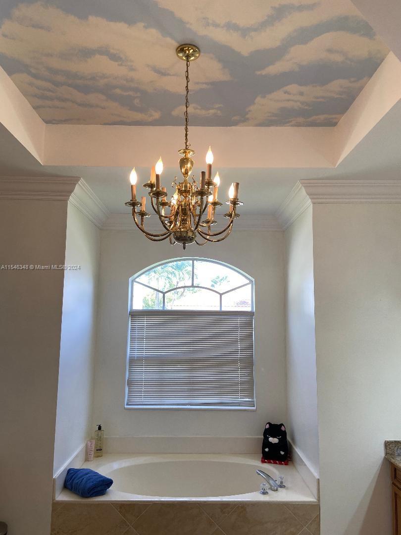 22323 Rushmore Place Boca Raton, FL 33428 - Photo 6 of 20 a view of a dining room with a chandelier
