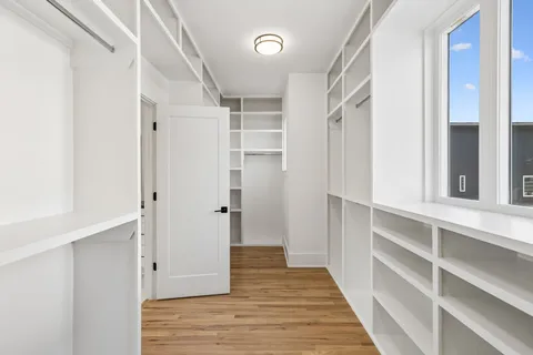 a view of a hallway view with wooden floor and staircase