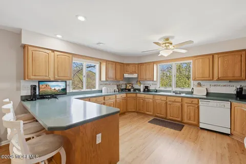 a kitchen with stainless steel appliances granite countertop a stove a sink dishwasher and a refrigerator