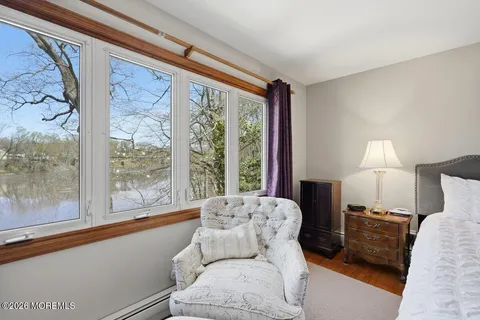 a bedroom with furniture and a large window