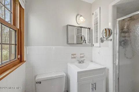 a bathroom with a sink a mirror and a toilet