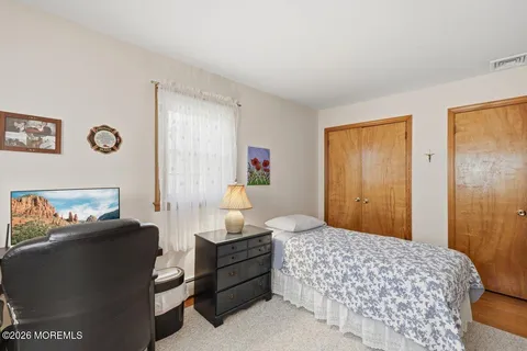 a bedroom with furniture and a window