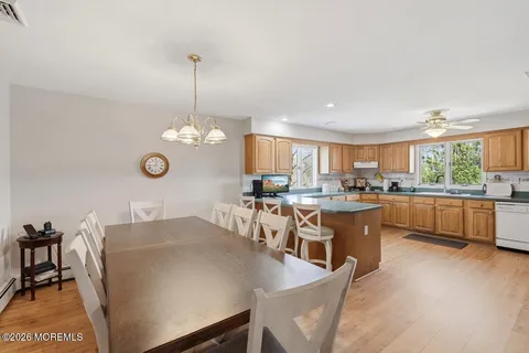 a large kitchen with a table and chairs