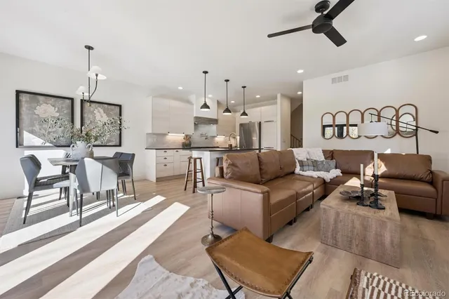 a living room with furniture and kitchen view