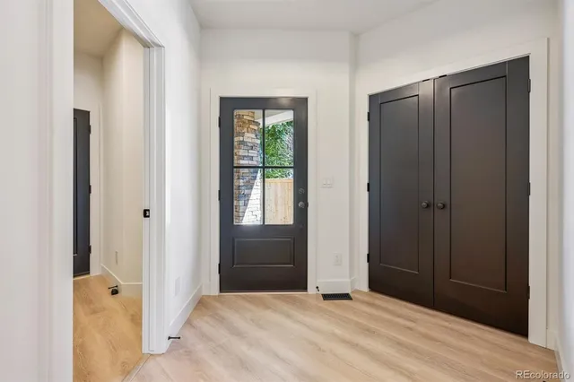 a view of an empty room with closet and a window