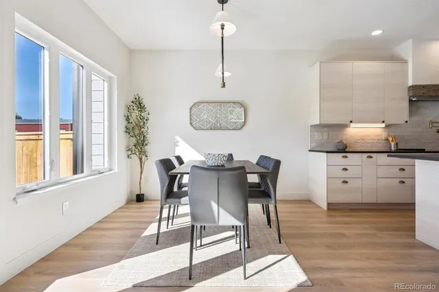 a view of a dining room with furniture window and wooden floor