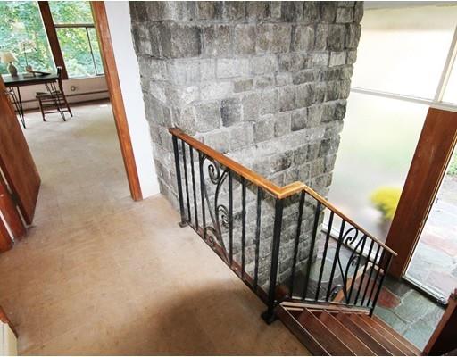 16 Foster Road Lexington, MA 02421 - Photo 14 of 21 a view of staircase with railing and a floor to ceiling window