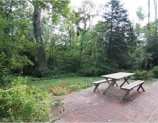 16 Foster Road Lexington, MA 02421 - Photo 20 of 21 a garden with a bench and some trees