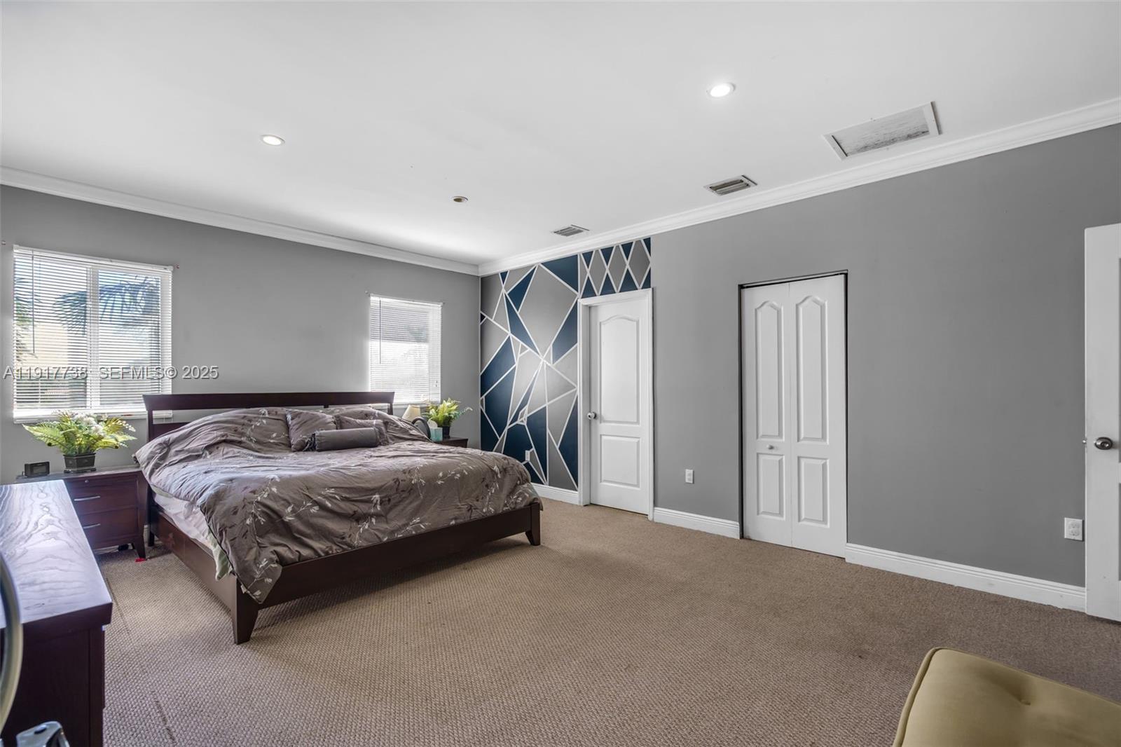 3135 Southwest 80th Avenue Miami, FL 33155 - Photo 34 of 65 a spacious bedroom with a bed and a chandelier