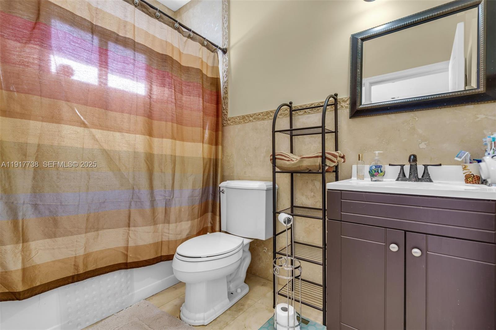 3135 Southwest 80th Avenue Miami, FL 33155 - Photo 36 of 65 a bathroom with a toilet sink vanity and mirror