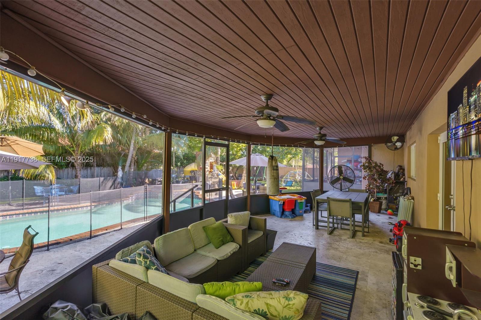 3135 Southwest 80th Avenue Miami, FL 33155 - Photo 45 of 65 a living room with patio furniture and a floor to ceiling window