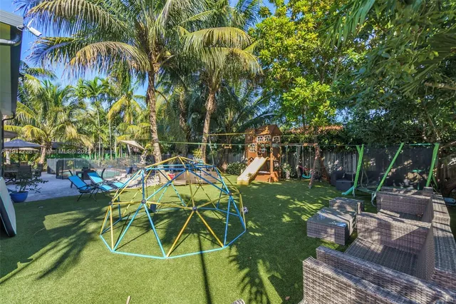an aerial view of a house with a yard and potted plants