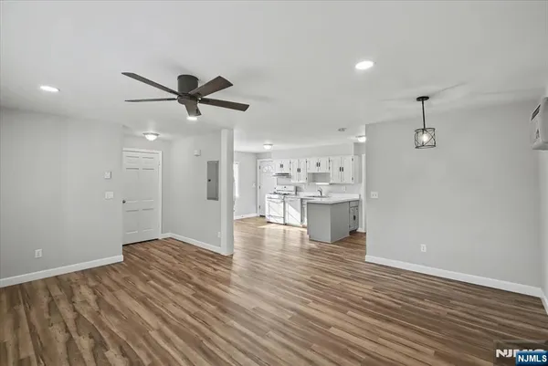 a view of a kitchen with wooden floor and a kitchen