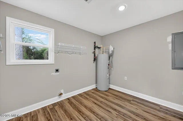 a view of empty room with wooden floor