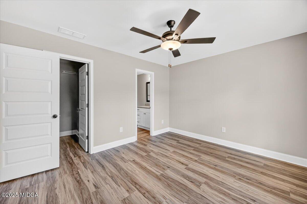 315 Lee Street Perry, GA 31069 - Photo 14 of 26 wooden floor in an empty room with a window
