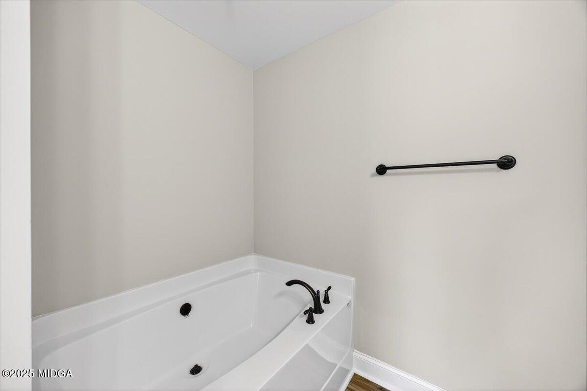 315 Lee Street Perry, GA 31069 - Photo 16 of 26 a bathroom with a tub and a shower