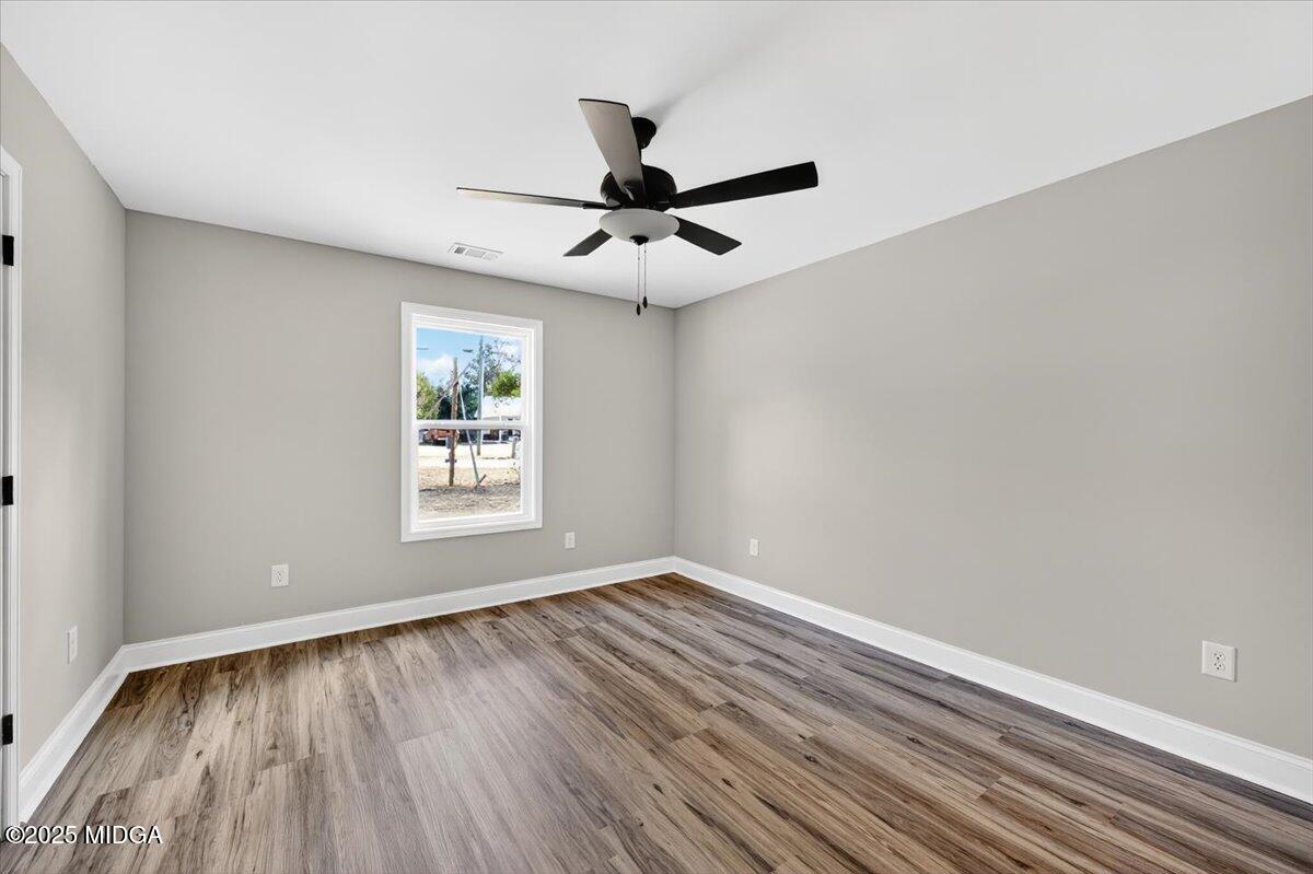 315 Lee Street Perry, GA 31069 - Photo 20 of 26 wooden floor in an empty room with a window