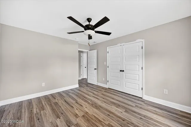 a view of an empty room and wooden floor