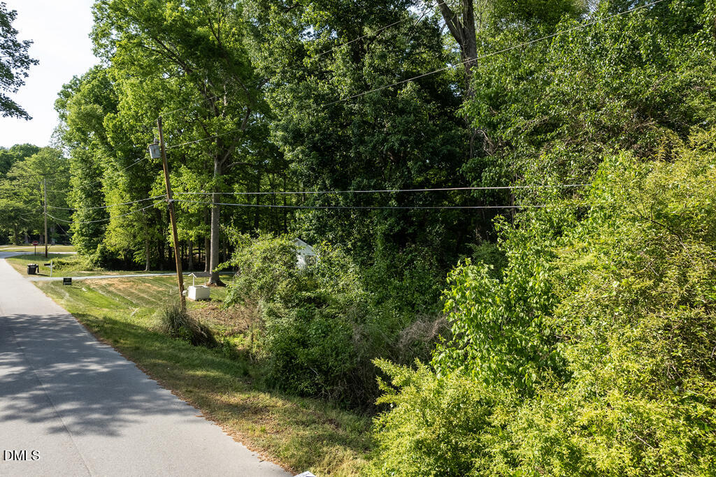 5809 Meadowlark Lane Raleigh, NC 27610 - Photo 5 of 14 a backyard of a house with lots of green space