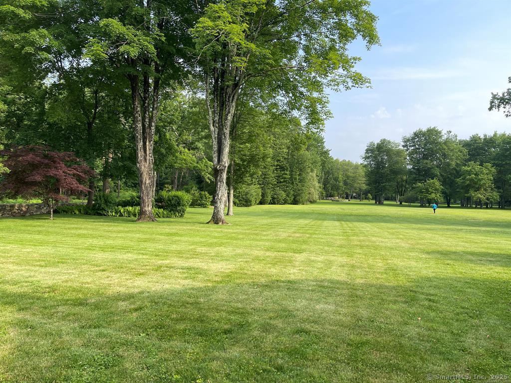 90 Redding Road Easton, CT 06612 - Photo 2 of 32 a view of a field with trees in the background