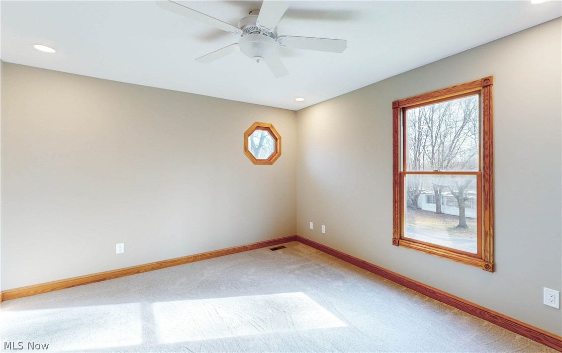 2081 Stroup Road Atwater, OH 44201 - Photo 33 of 48 Spare room featuring a wealth of natural light, light carpet, and ceiling fan