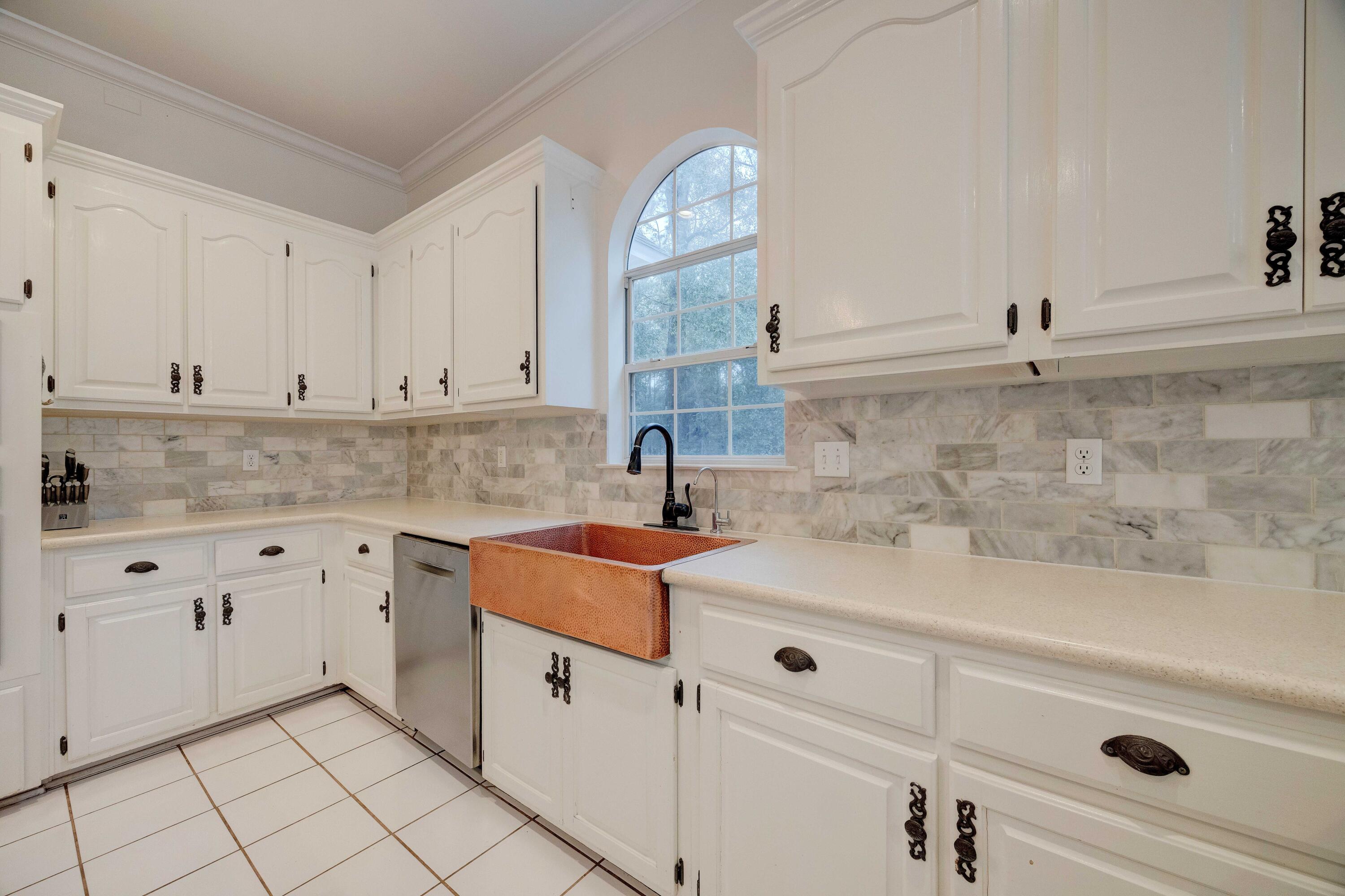 1111 Tallokas Road Crestview, FL 32536 - Photo 12 of 56 a kitchen with granite countertop white cabinets and white appliances