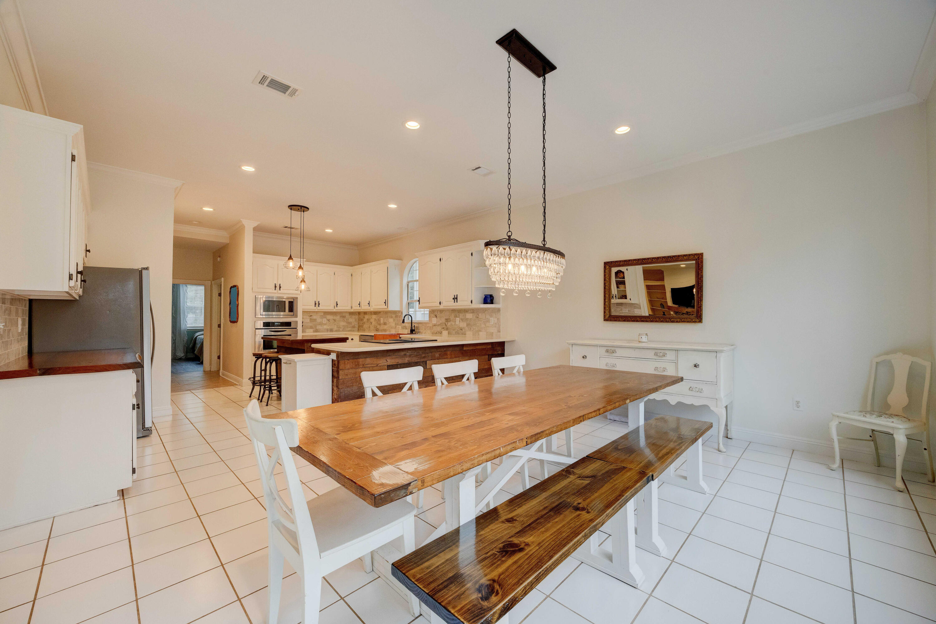 1111 Tallokas Road Crestview, FL 32536 - Photo 15 of 56 a living room with stainless steel appliances kitchen island granite countertop a table chairs and a view of living room