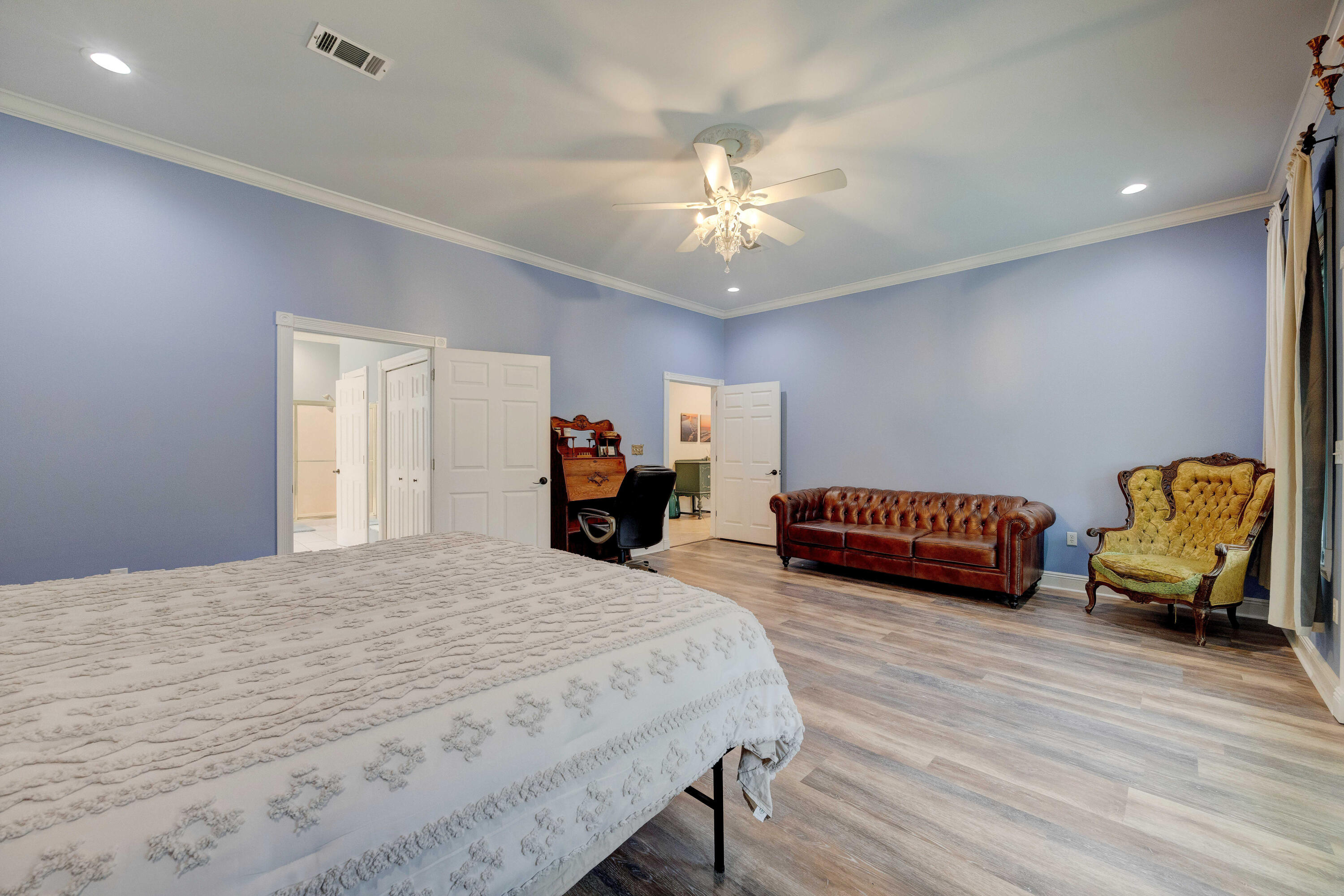 1111 Tallokas Road Crestview, FL 32536 - Photo 19 of 56 a bedroom with a bed and a chandelier