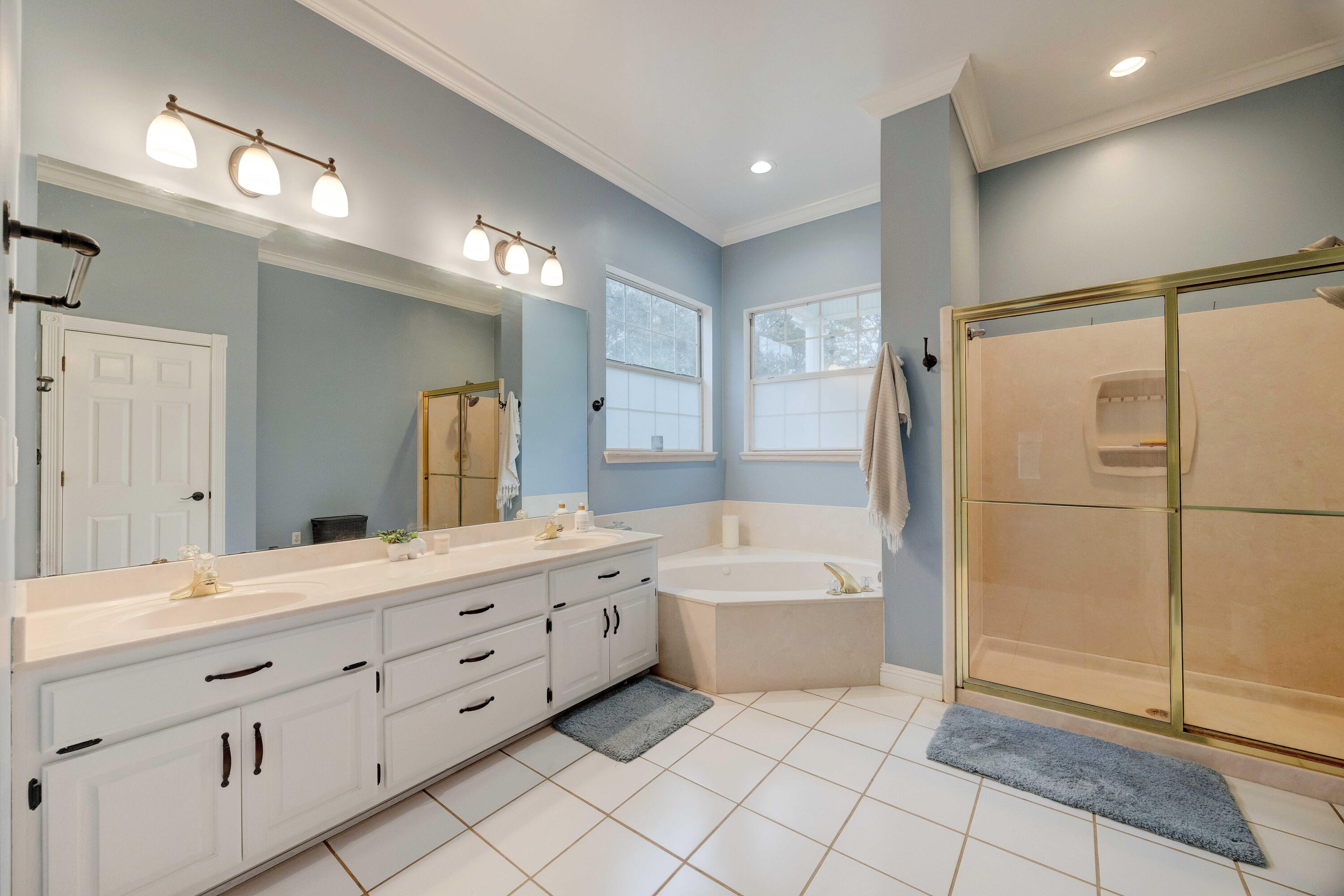 1111 Tallokas Road Crestview, FL 32536 - Photo 20 of 56 a spacious bathroom with a double vanity sink a mirror and a bathtub