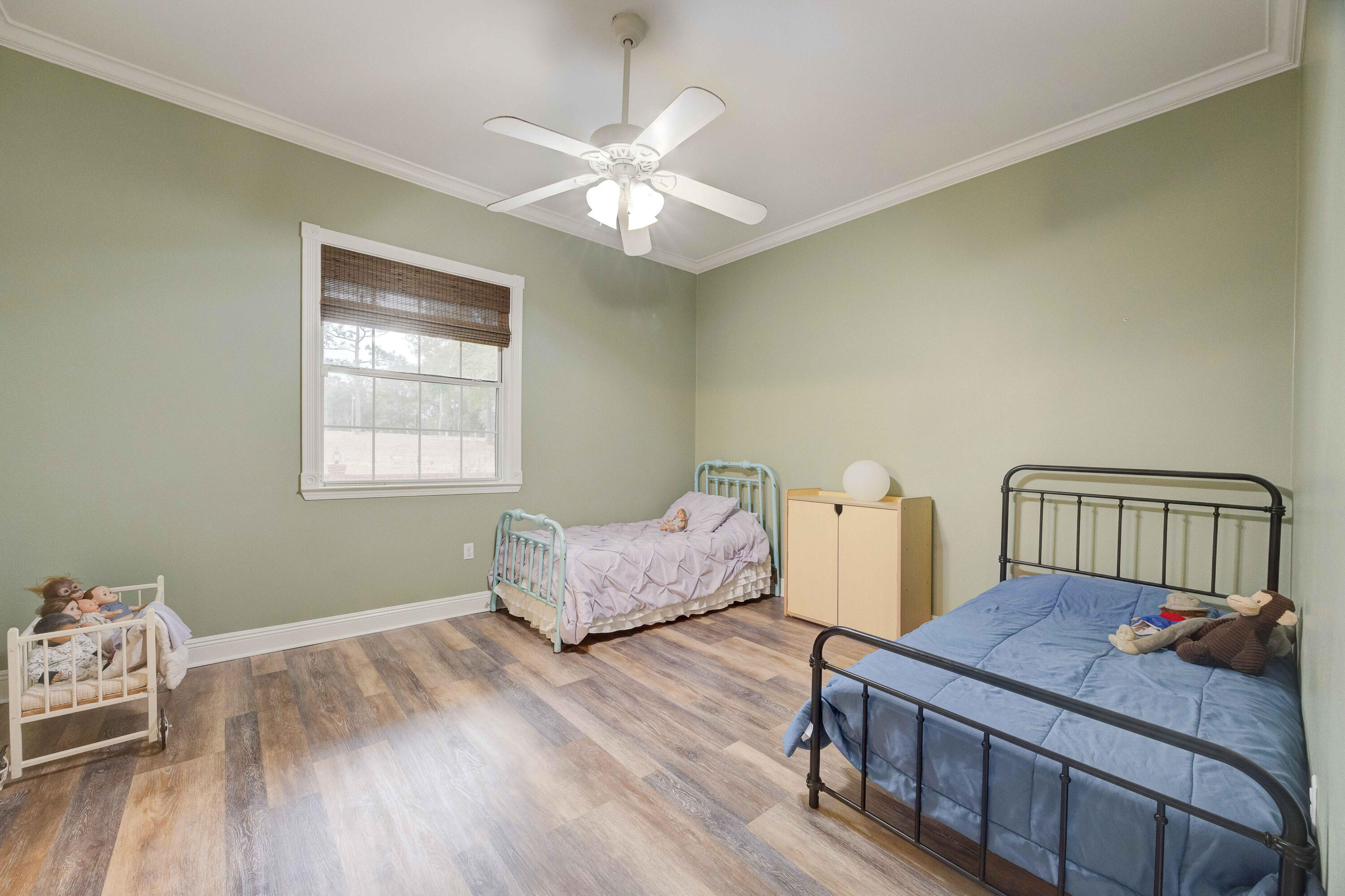 1111 Tallokas Road Crestview, FL 32536 - Photo 21 of 56 a room with furniture and a wooden floor