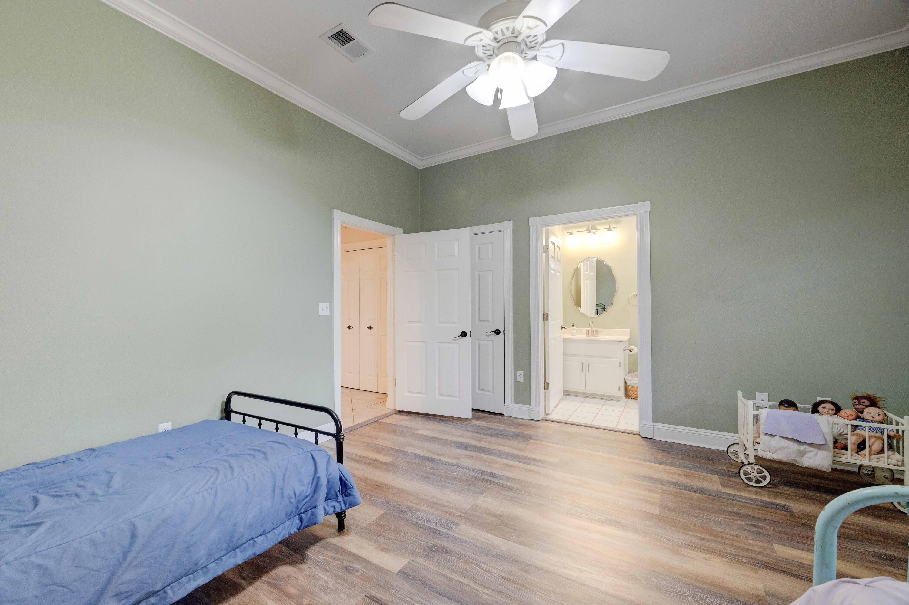 1111 Tallokas Road Crestview, FL 32536 - Photo 22 of 56 a bedroom with a bed and a chandelier