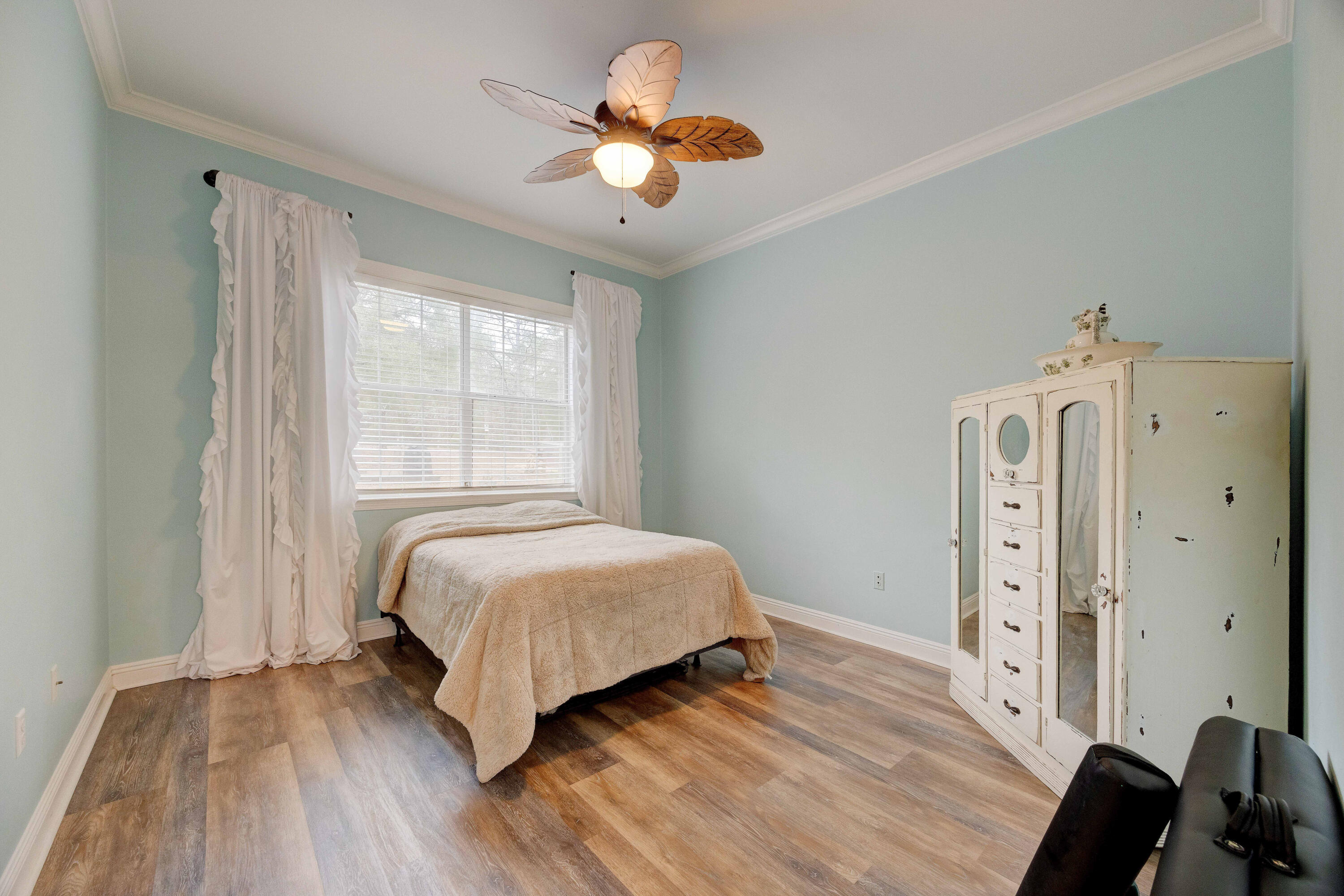 1111 Tallokas Road Crestview, FL 32536 - Photo 24 of 56 a bedroom with a bed and a chandelier