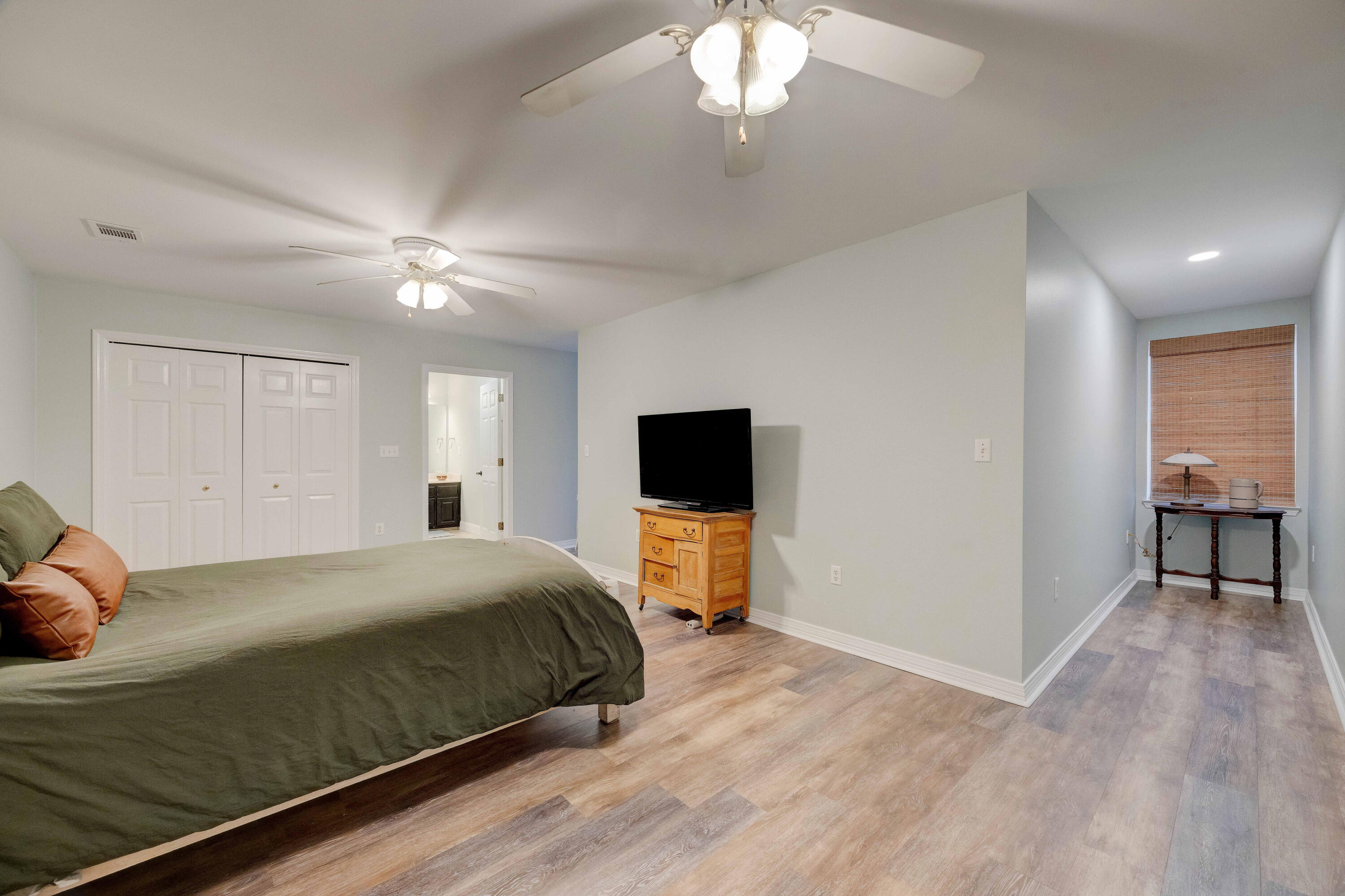 1111 Tallokas Road Crestview, FL 32536 - Photo 26 of 56 a bedroom with a bed and a chandelier
