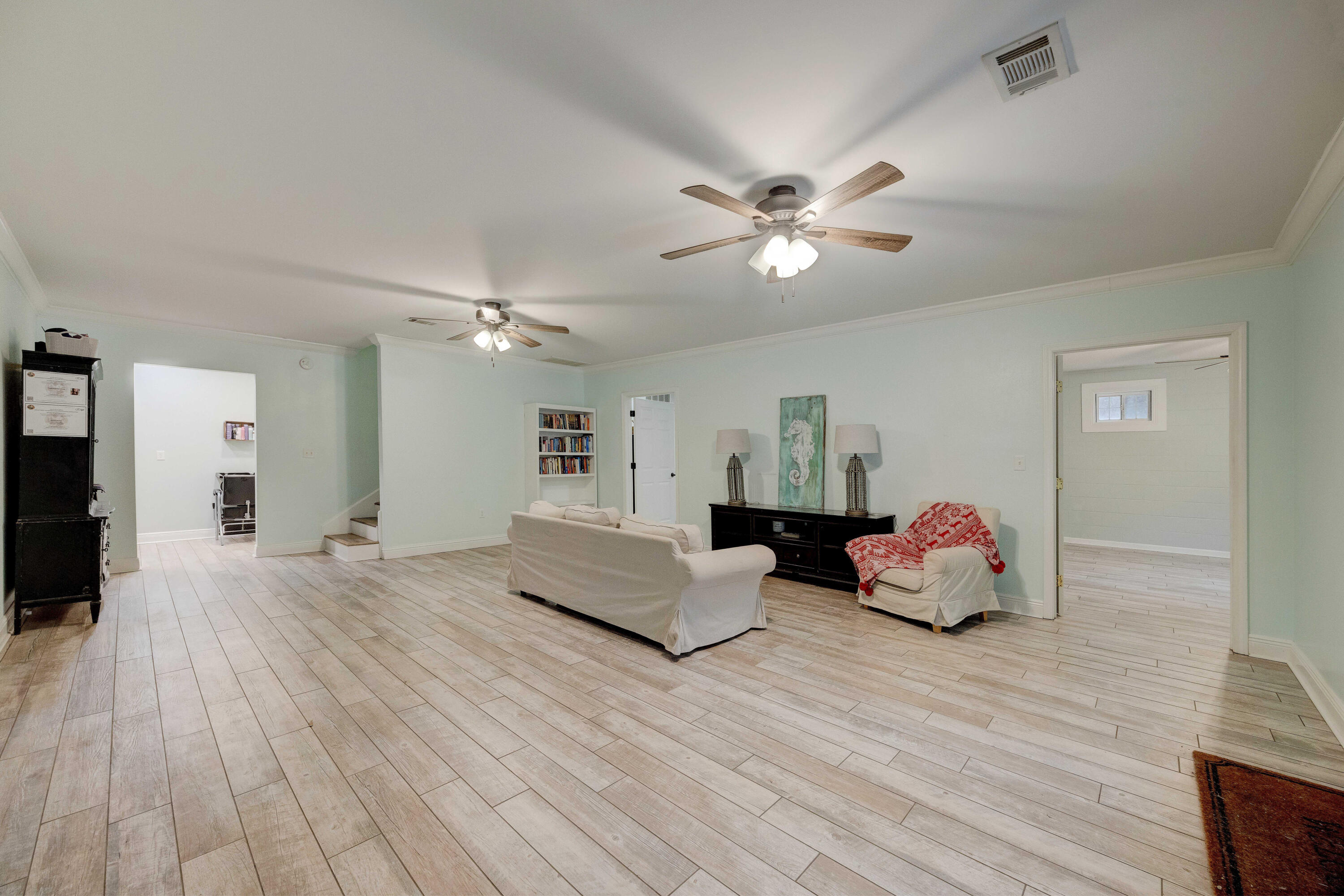 1111 Tallokas Road Crestview, FL 32536 - Photo 29 of 56 a living room with furniture and wooden floor
