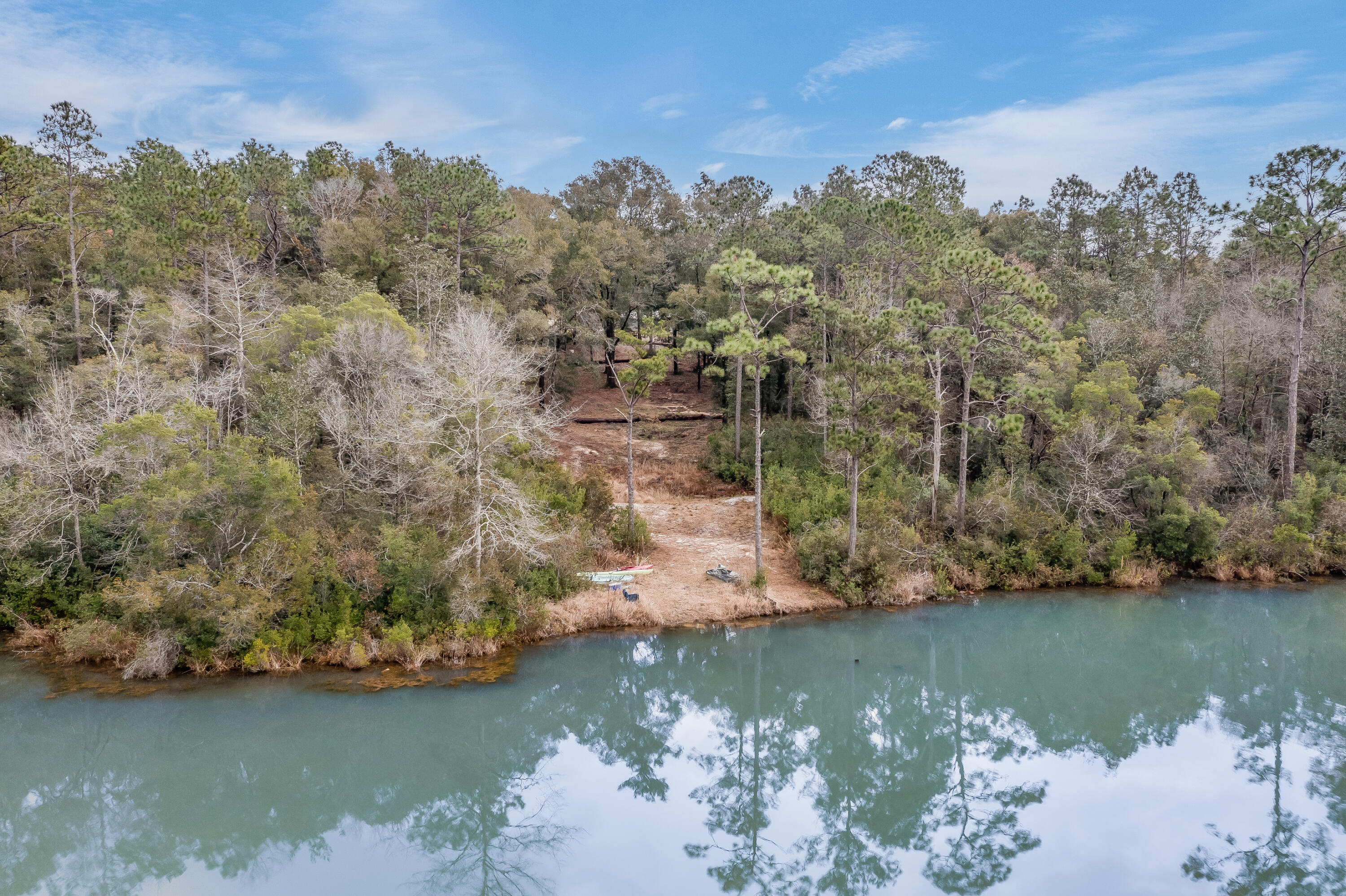 1111 Tallokas Road Crestview, FL 32536 - Photo 39 of 56 a view of a lake with a mountain in the background