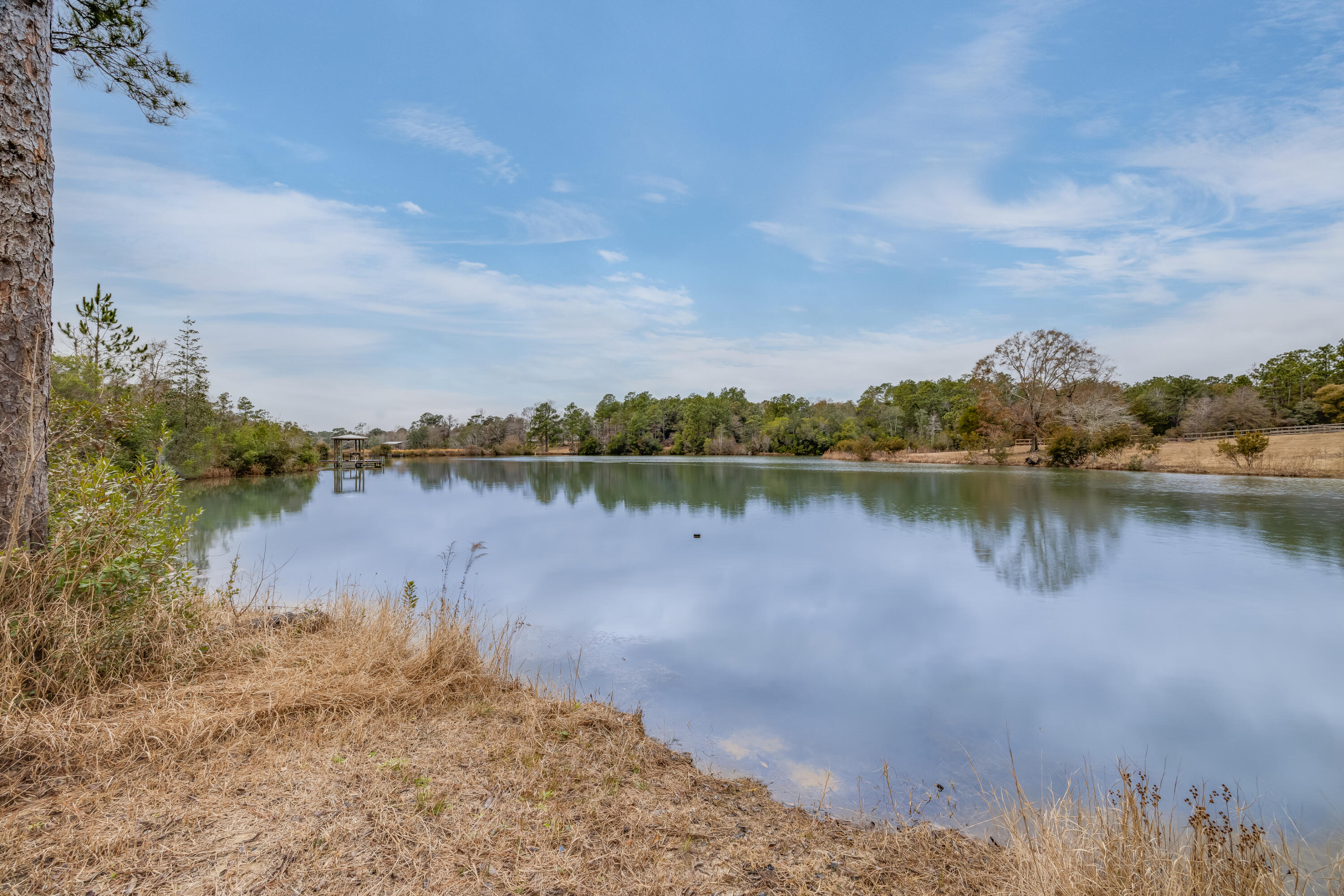 1111 Tallokas Road Crestview, FL 32536 - Photo 50 of 56 a view of a lake with houses in the back