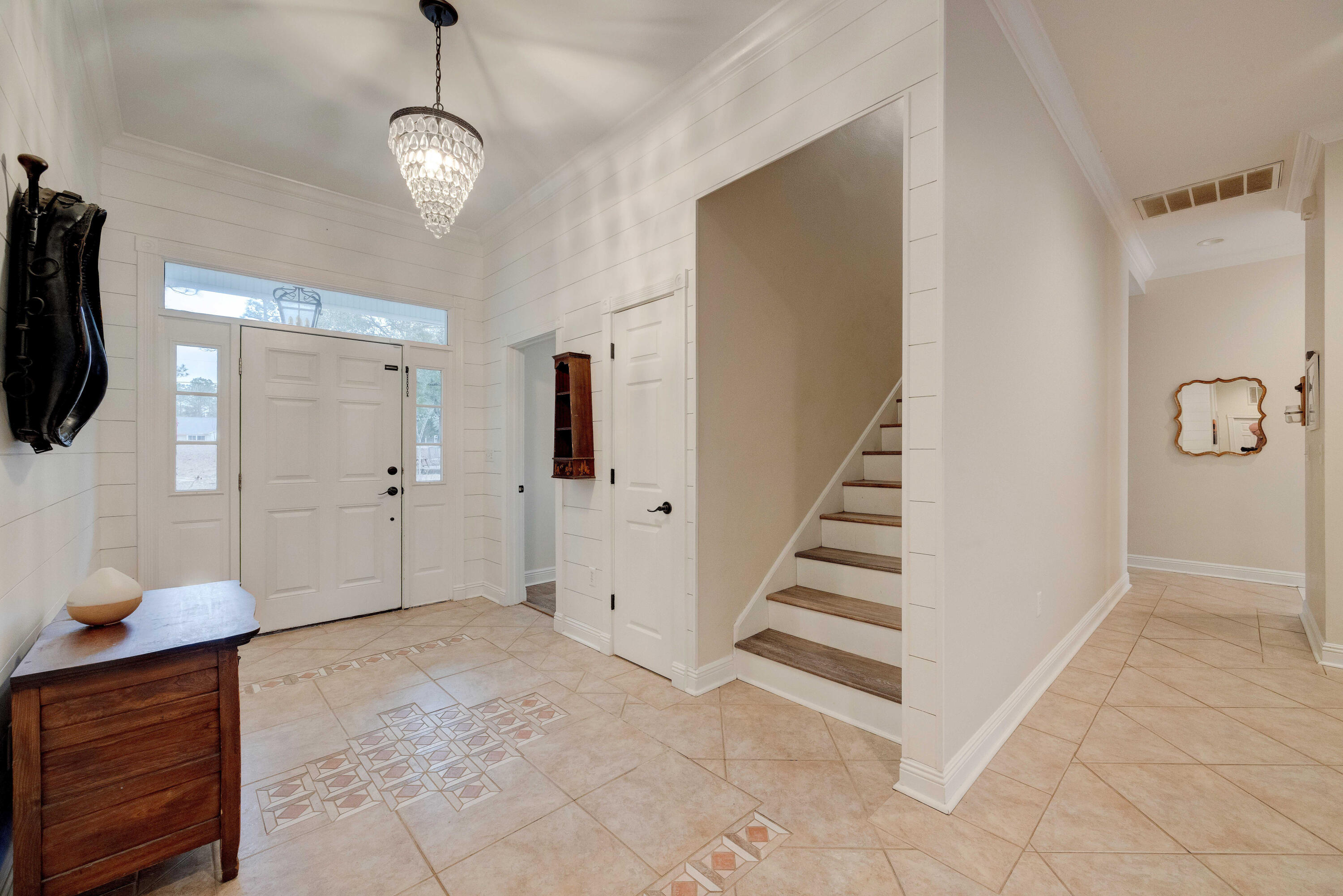 1111 Tallokas Road Crestview, FL 32536 - Photo 6 of 56 a view of a livingroom with wooden floor and stairs