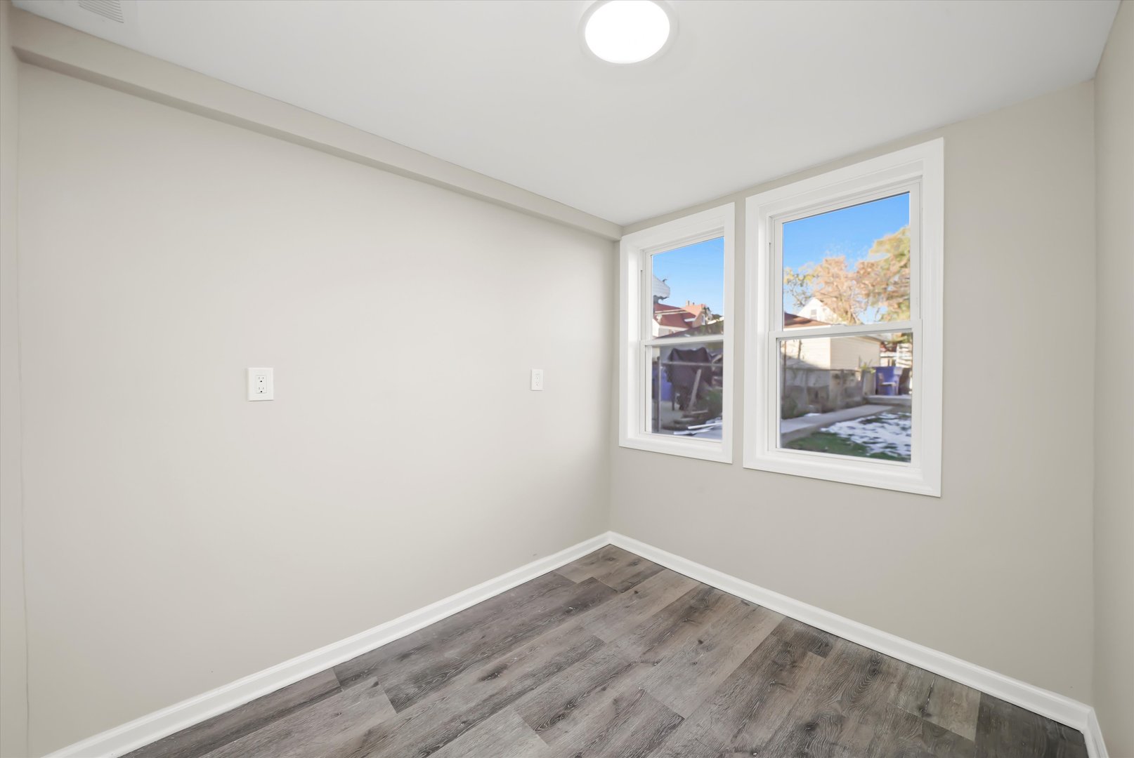 2510 North Linder Avenue Chicago, IL 60639 - Photo 19 of 30 a view of an empty room with wooden floor and a window
