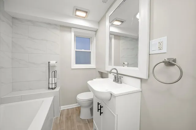 a bathroom with a sink toilet and shower