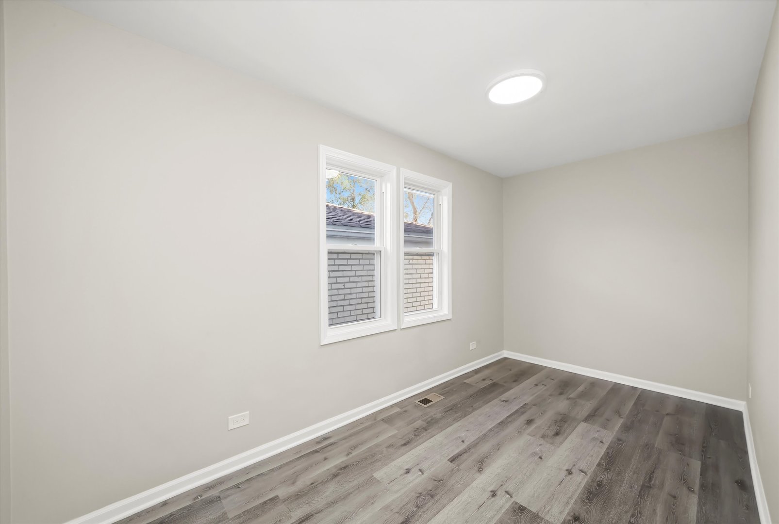2510 North Linder Avenue Chicago, IL 60639 - Photo 7 of 30 an empty room with wooden floor and windows