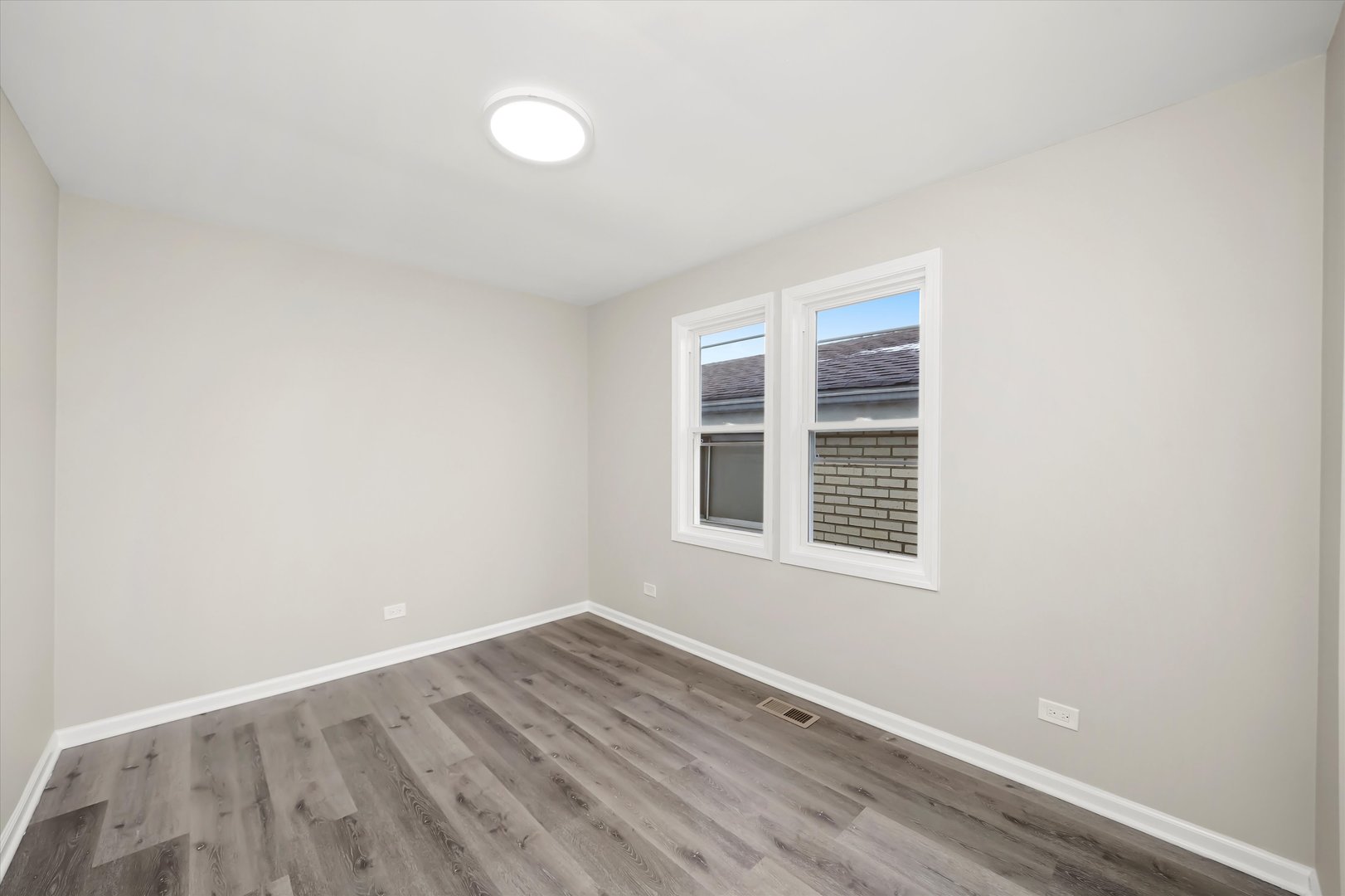 2510 North Linder Avenue Chicago, IL 60639 - Photo 8 of 30 a view of an empty room with wooden floor and a window