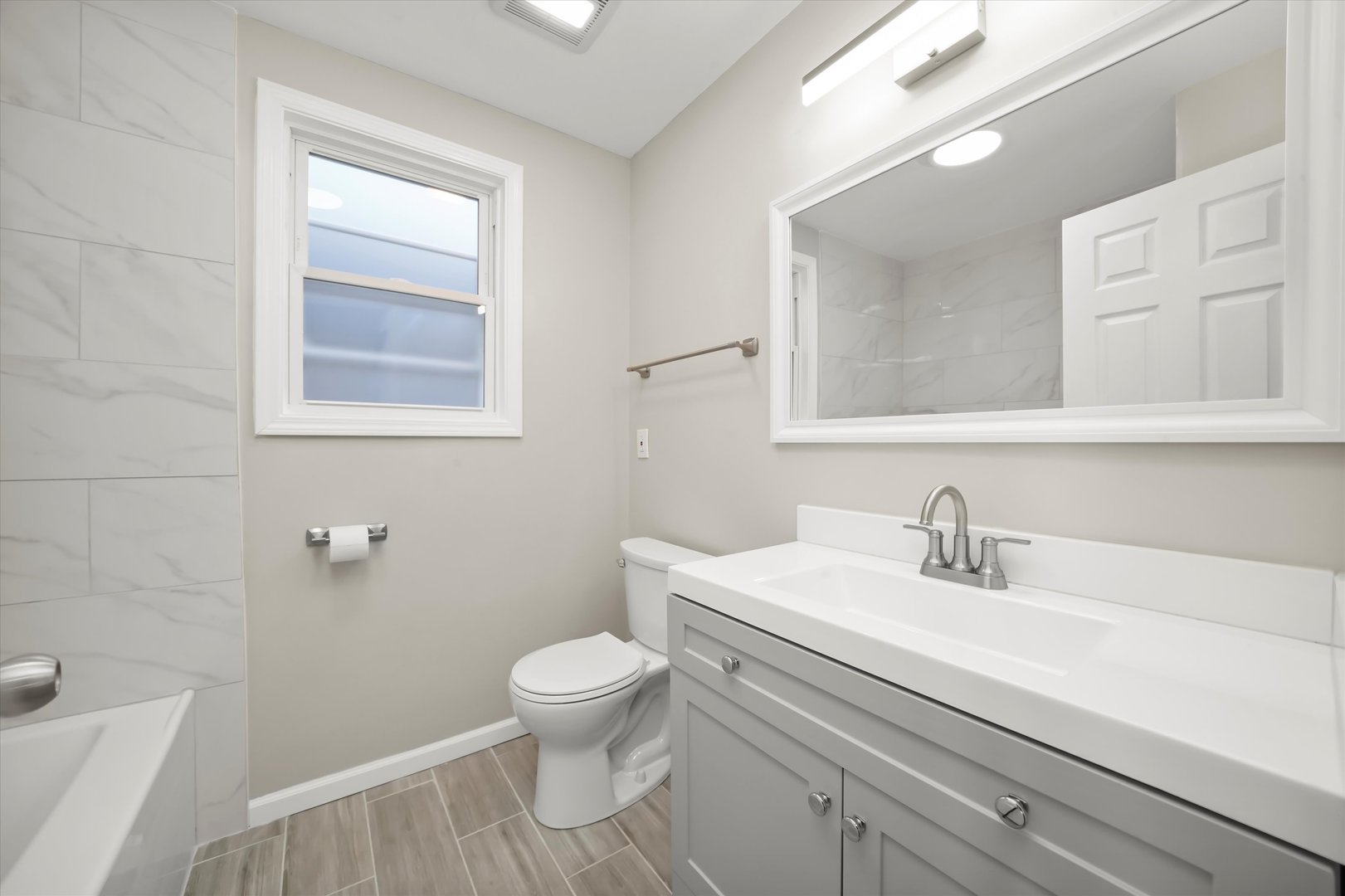 2510 North Linder Avenue Chicago, IL 60639 - Photo 9 of 30 a bathroom with a sink a toilet and a mirror