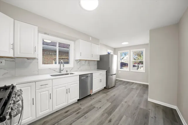 a kitchen with granite countertop white cabinets and white appliances