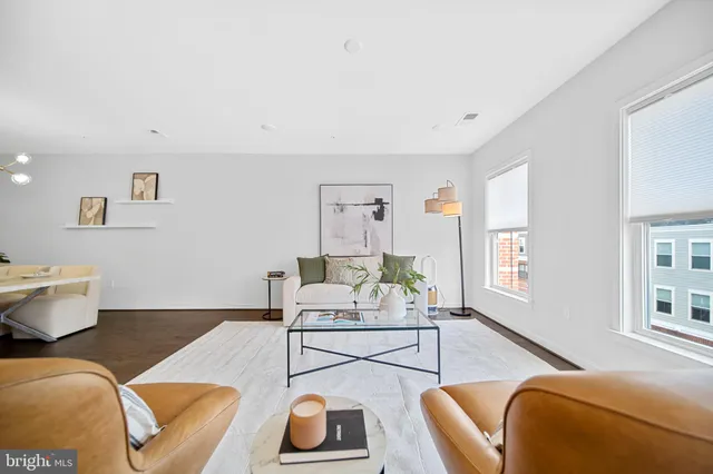 a living room with furniture and kitchen view