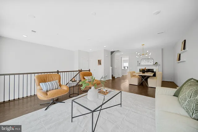 a view of a dining room with furniture wooden floor and chandelier