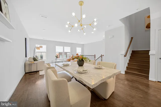 a view of a dining room with furniture wooden floor and chandelier