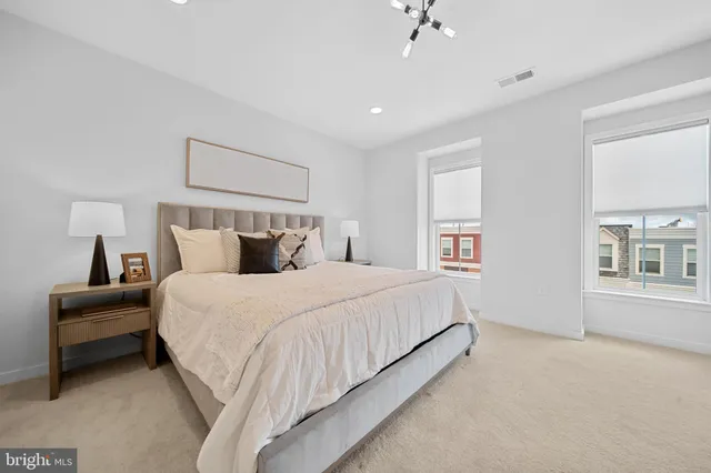 a bedroom with a bed and a night stand