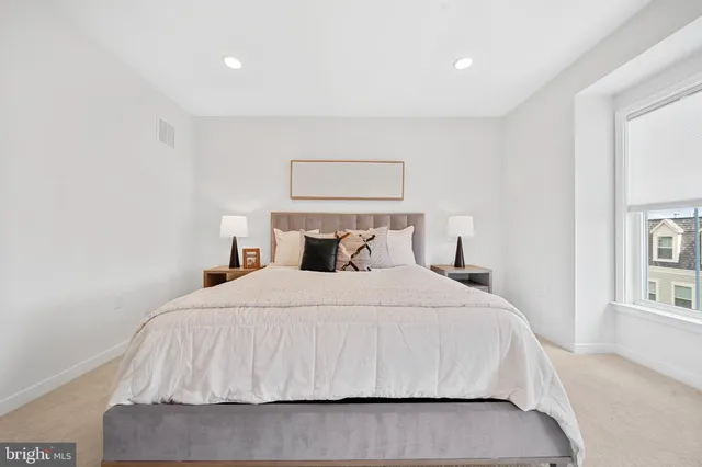 a bathroom with a double vanity sink mirror and toilet