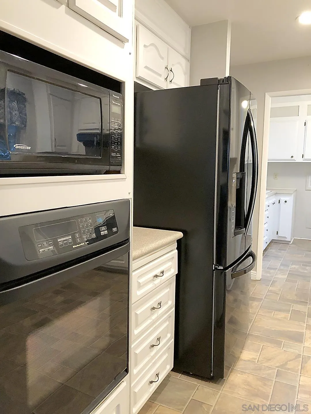 3367 Don Pablo Drive Carlsbad, CA 92010 - Photo 6 of 25 a kitchen with stainless steel appliances a refrigerator and cabinets