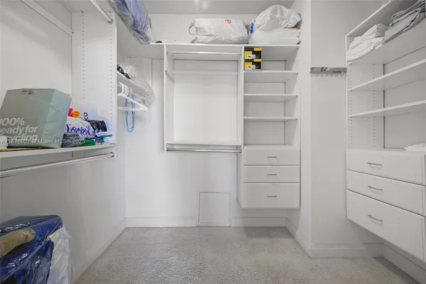 a view of storage and utility room with racks on the wall